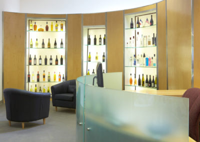 lobby-with-chairs-desk-and-wine-on-shelves
